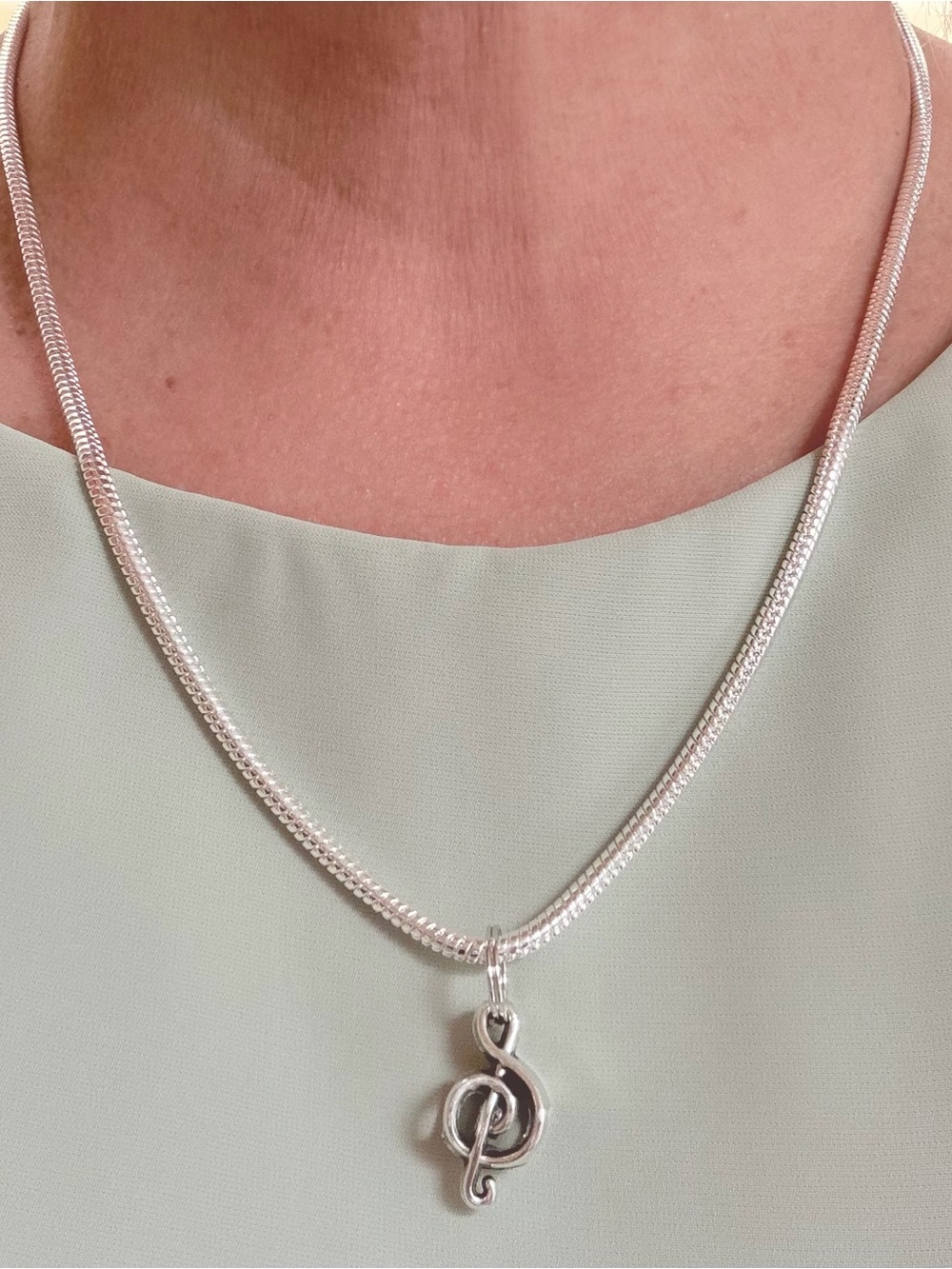925 sterling silver Necklace.Snake chain with Treble clef pendant.19”. Unisex.